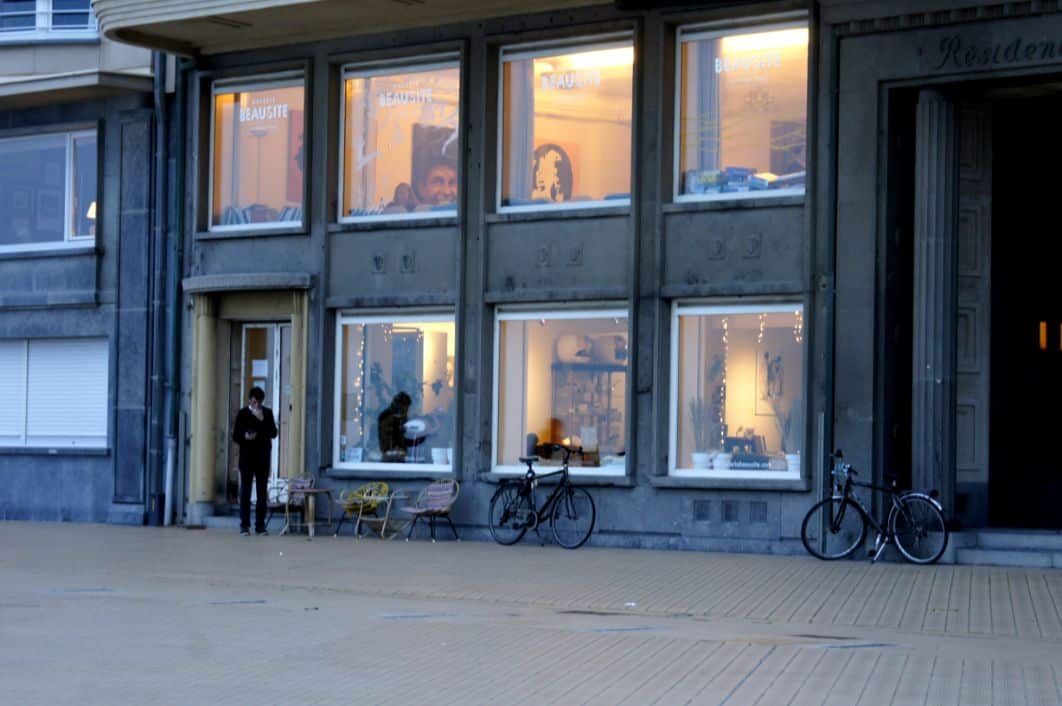 Windows to a coffee shop at the beach promenade in Ostend at blue hour
