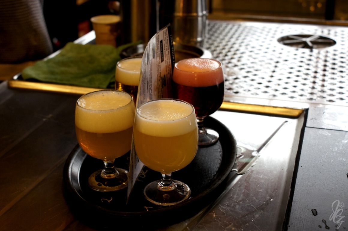 Selection of local beers for tasting at The Beer Wall in Bruges.