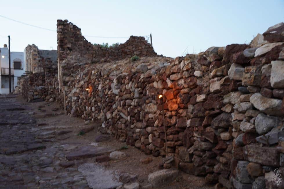 Old walls with torches in Kimolos