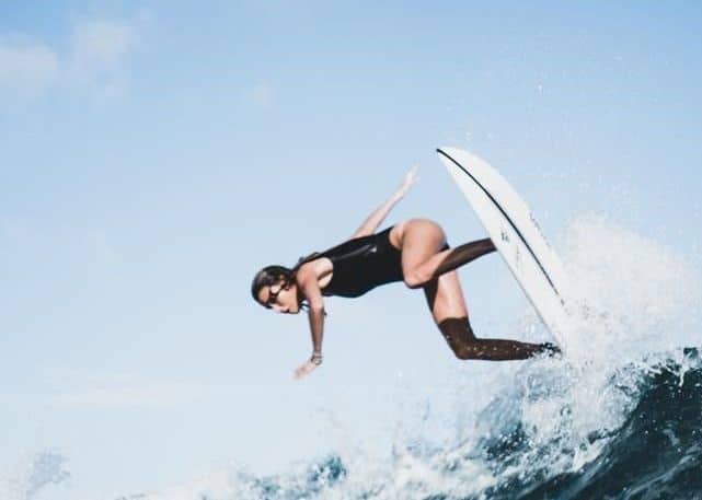 Surfer on a board by Nomads Surfing