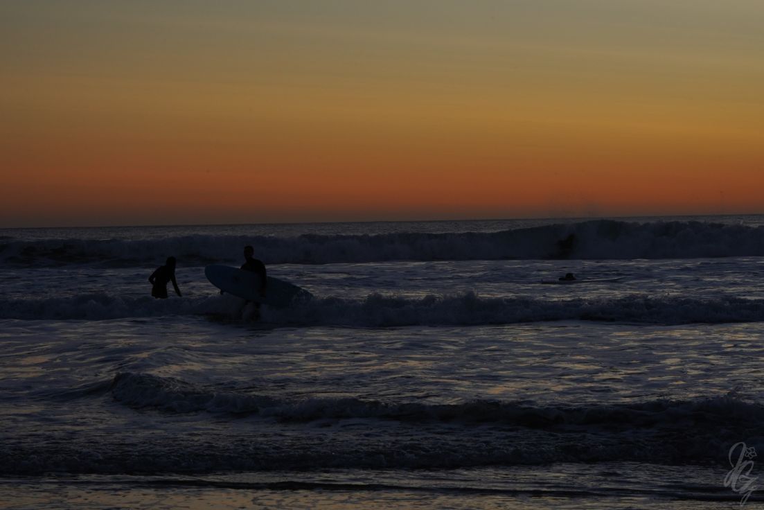 Surfing at sunset in El Palmar