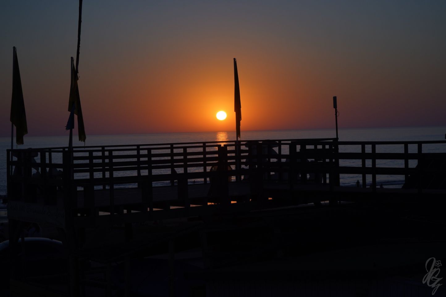 Flags of Take Surf in El Palmar at sunset