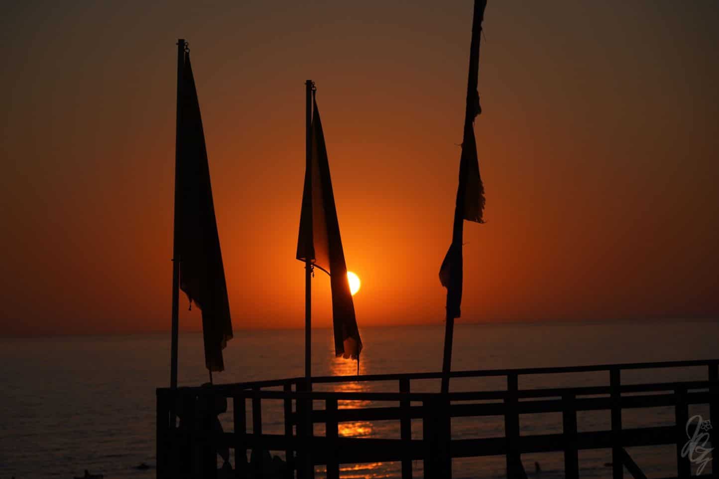 Flags of Take Surf in El Palmar at sunset