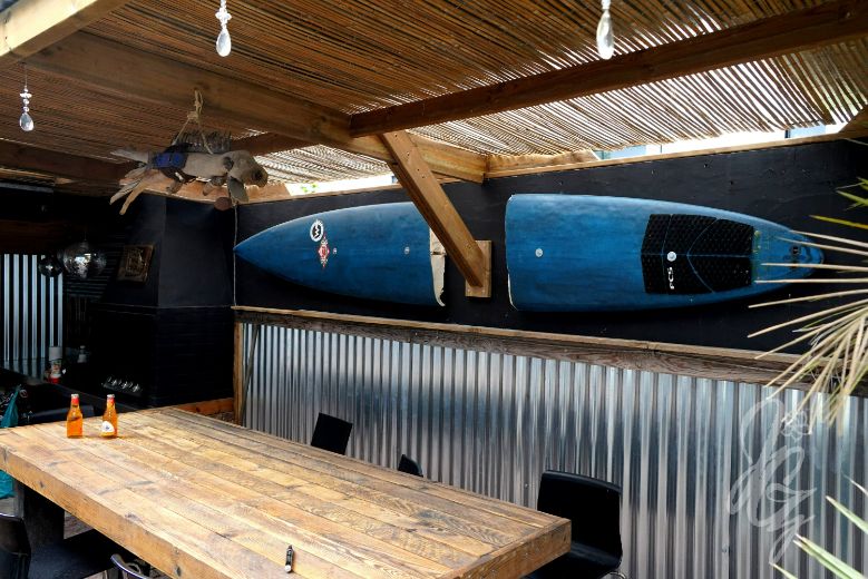 Broken surfboard in the bar at the back of Carwyn's House