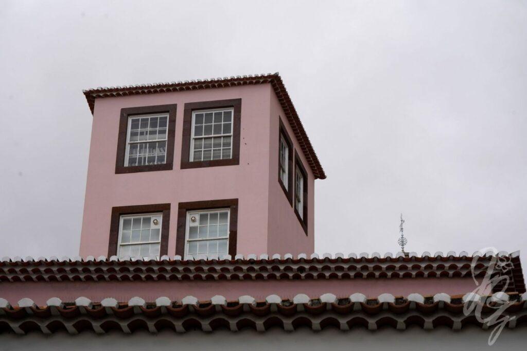 House in Funchal with multiple layers of tiles and a tower
