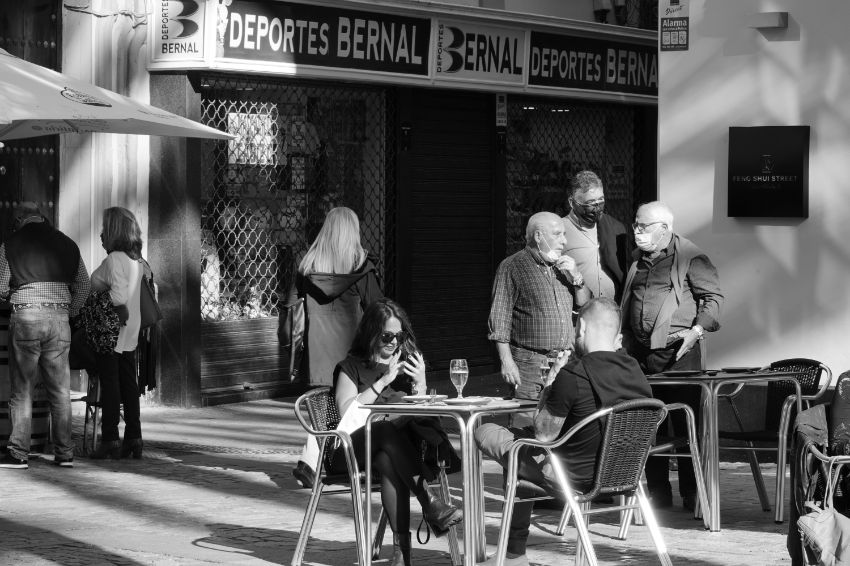 People sitting in front of a restaurant in Cadiz