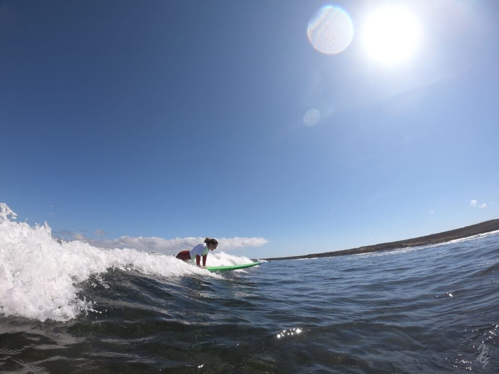 Girl surfing at the North Shore in Fuerteventura
