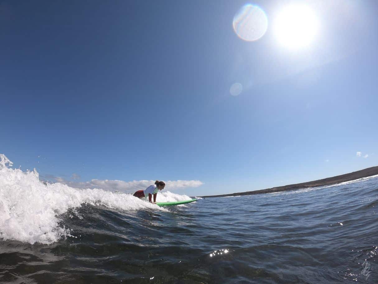 Girl surfing at the North Shore in Fuerteventura