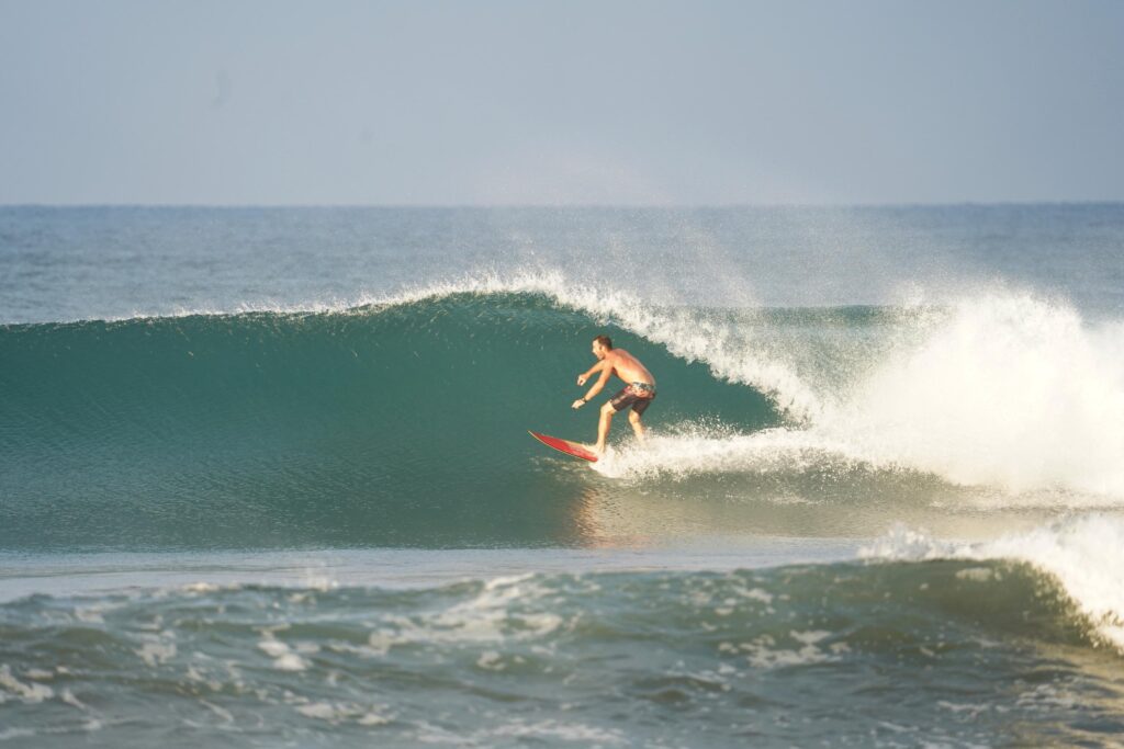 Surfing at Dominical beach in Costa Rica