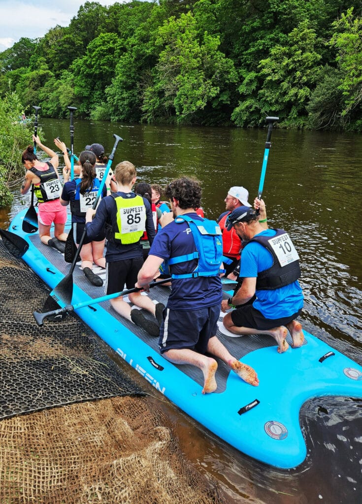 Paddleboarders on the river Eden during SUPfest