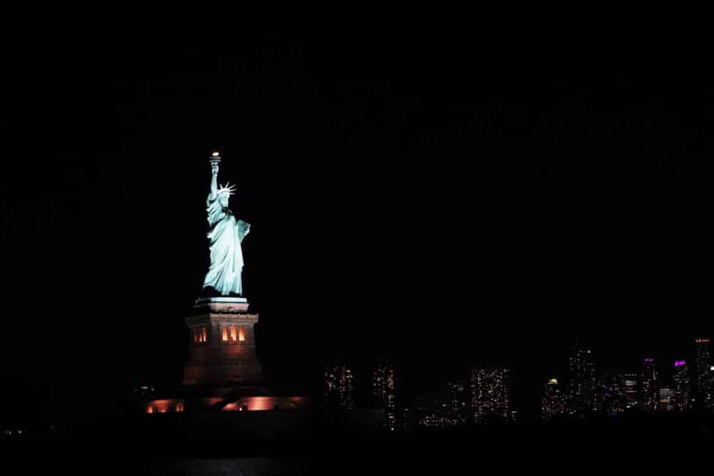 Statue of Liberty and New York skyline at night