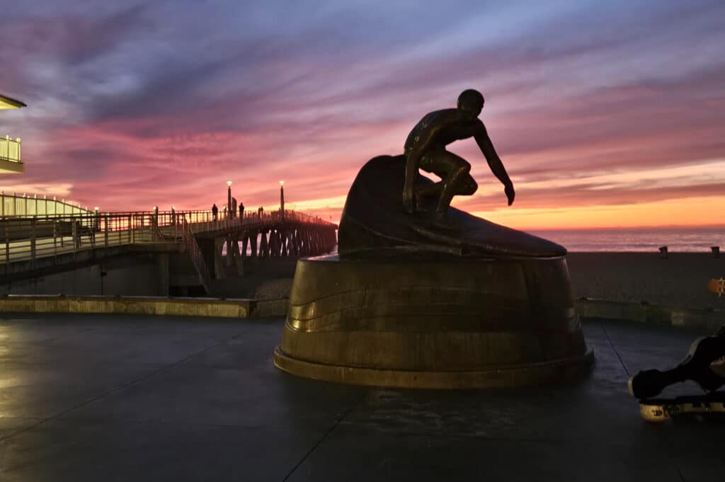 Statue at the Surfers Walk of Fame at Hermosa Beach at sunset